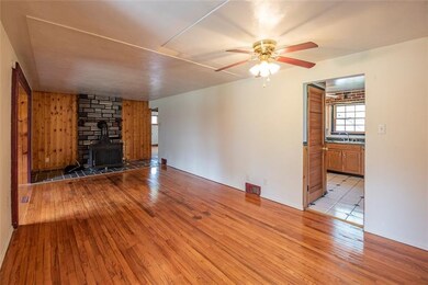 The living room features a Franklin stove.