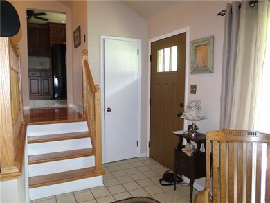 Open foyer with ceramic tile and new front door.