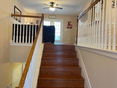 The Foyer from the front door looking up into the living room. 
