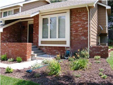 Professional landscaping beds and mature trees wel
