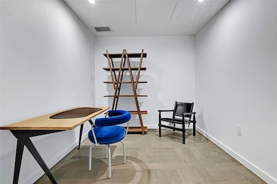 Office area featuring attic access, baseboards, a