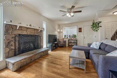 This family room features a cozy stone fireplace, 