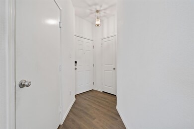 Hall with wood finished floors and baseboards