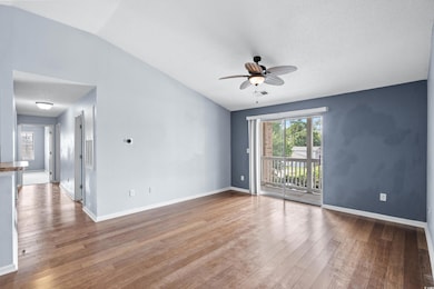 Spare room featuring lofted ceiling, ceiling fan, 