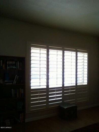 front windows with wood blinds