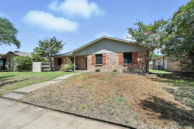 Single story home with board and batten siding, brick siding, and a porch