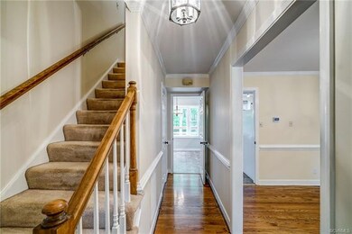Foyer has hardwood floors and nice moldings