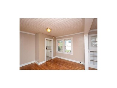 Open room with plenty of light leading into kitche