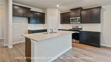 Kitchen with tasteful backsplash, sink, an island