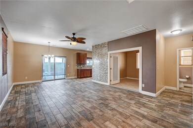 Unfurnished living room with ceiling fan, wood fin