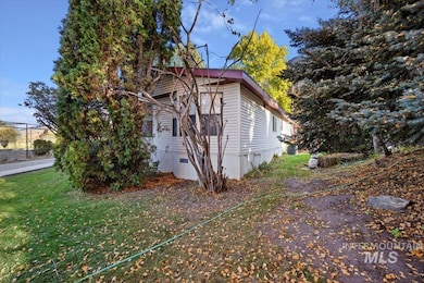 View of side of home with a yard