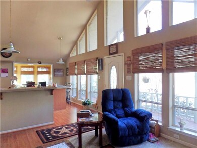 Wall of windows across kitchen and living