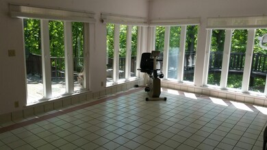 Enclosed spacious sun porch.  Completely tiled flo