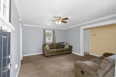Living room with a textured ceiling, ceiling fan, 