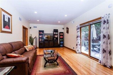 The spacious living room has a Pella sliding door 