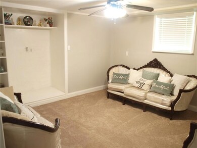 Living room featuring ceiling fan and carpet