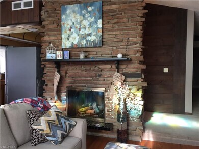 Stone fireplace in living room is very inviting !