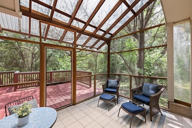 Sunroom with plenty of natural light and a view o