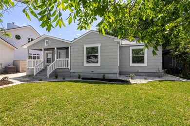 Bungalow with a front yard and cooling unit