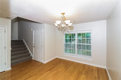 Unfurnished dining area featuring hardwood / wood-