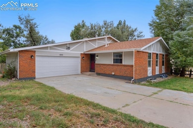 View of front facade with brick siding, driveway, a garage, a front yard, and a shingled roof