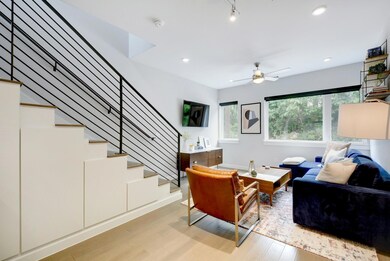 Living area featuring a ceiling fan, recessed lig