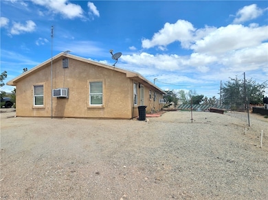 View of side of home featuring stucco siding and a
