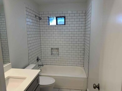 Bathroom featuring toilet, vanity, and shower / b