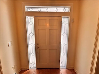 Tiled entrance foyer with baseboards