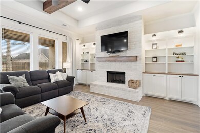 Living area featuring visible vents, crown molding