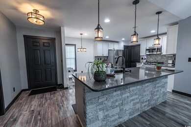 Kitchen featuring hanging light fixtures, a large 
