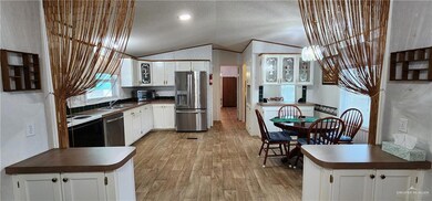Kitchen with sink, white cabinetry, and stainless steel appliances