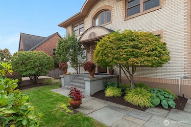 The front yard is perfectly manicured, and the wide front porch welcomes guests.