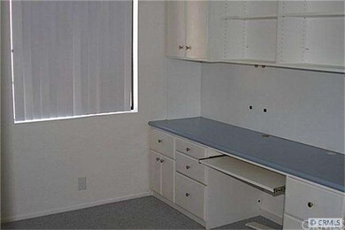 Second bedroom with built-in desk.