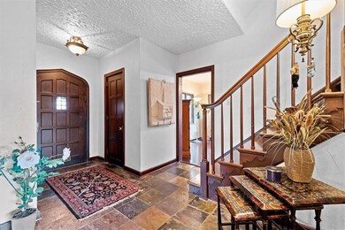 2 STORY FOYER WITH SLATE FLOORING.