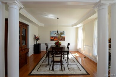 Dining room has a tray ceiling, picture frame mold
