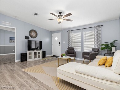 Living room with wood-type flooring and ceiling fa