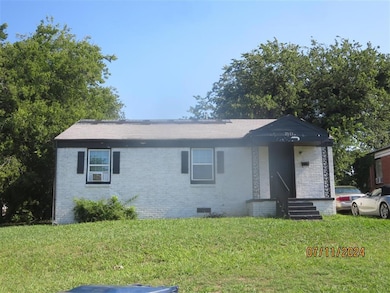 View of front of property with brick siding, a front lawn, crawl space, and entry steps