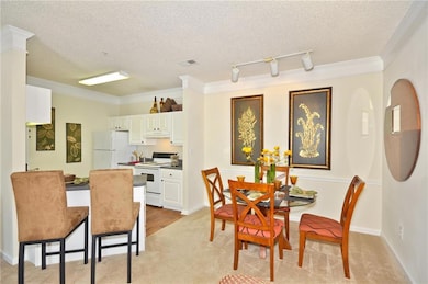 Dining area featuring a textured ceiling, light co