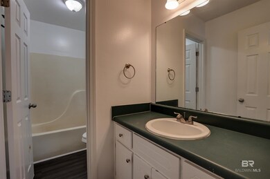 Bathroom featuring hardwood / wood-style floors, vanity, and toilet