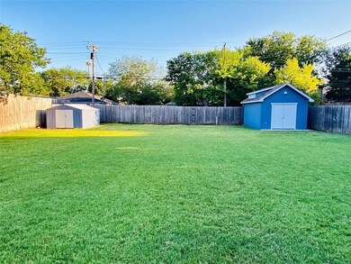 View of yard featuring a storage unit
