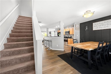 Dining space with wood finished floors, baseboards