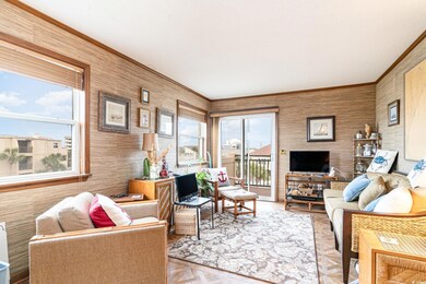 Living room featuring crown molding and parquet fl