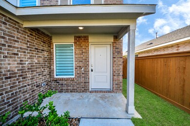 Charming front porch with a brick exterior, featur