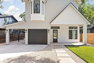 View of front of property with driveway and a gar
