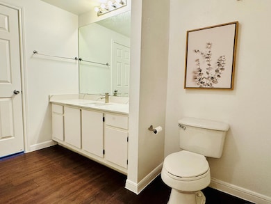 Half bath featuring vanity and wood finished floo