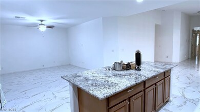 family room with ceiling fan and light