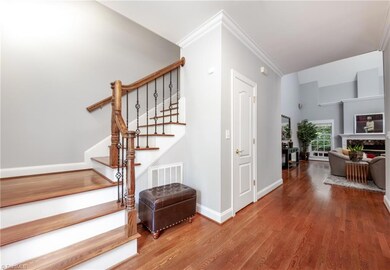 As you enter the home, you're greeted by wood floors, a large great room and formal dining room (to the right)
