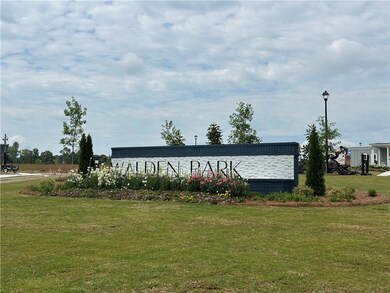 Community / neighborhood sign featuring a yard