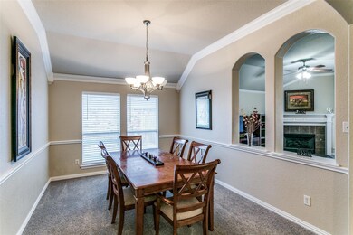 Dining space with ceiling fan with notable chandel